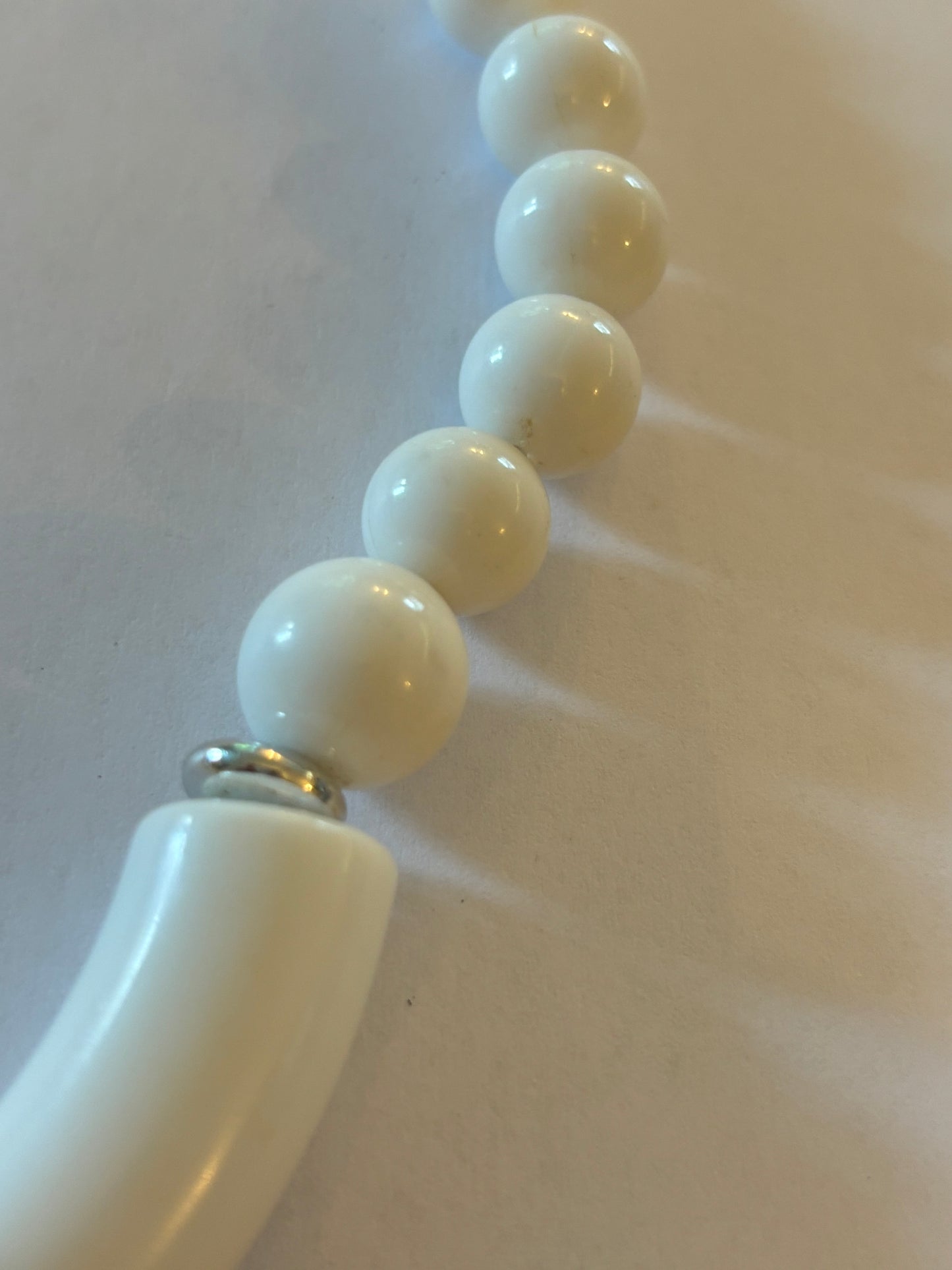 White and tube like large beaded necklace