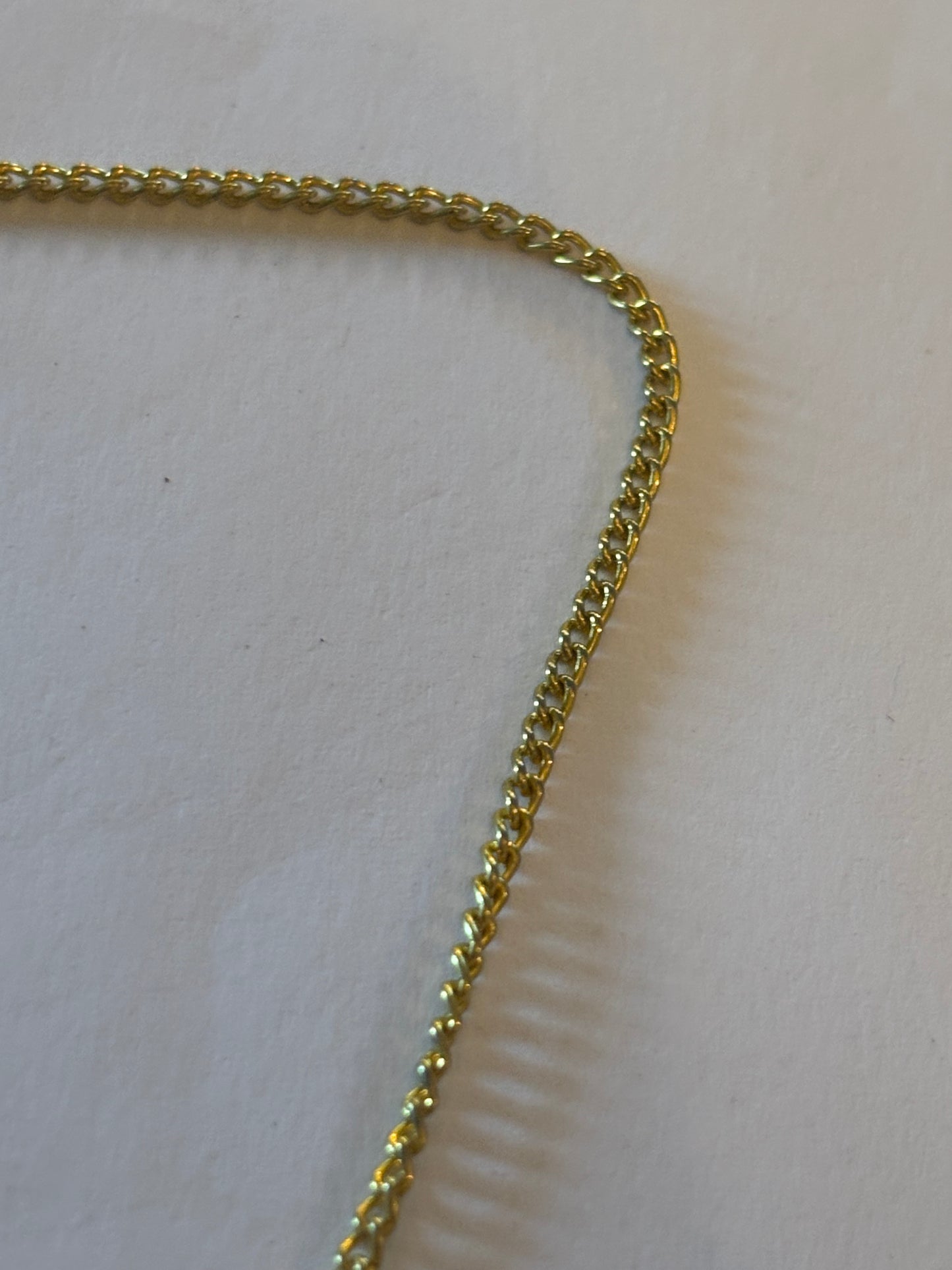 Gold chain necklace with seashell pendant trimmed with gold