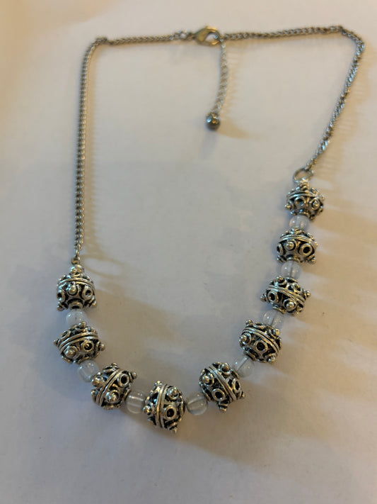 Bright silver ornate bead necklace with cloudy white spacers