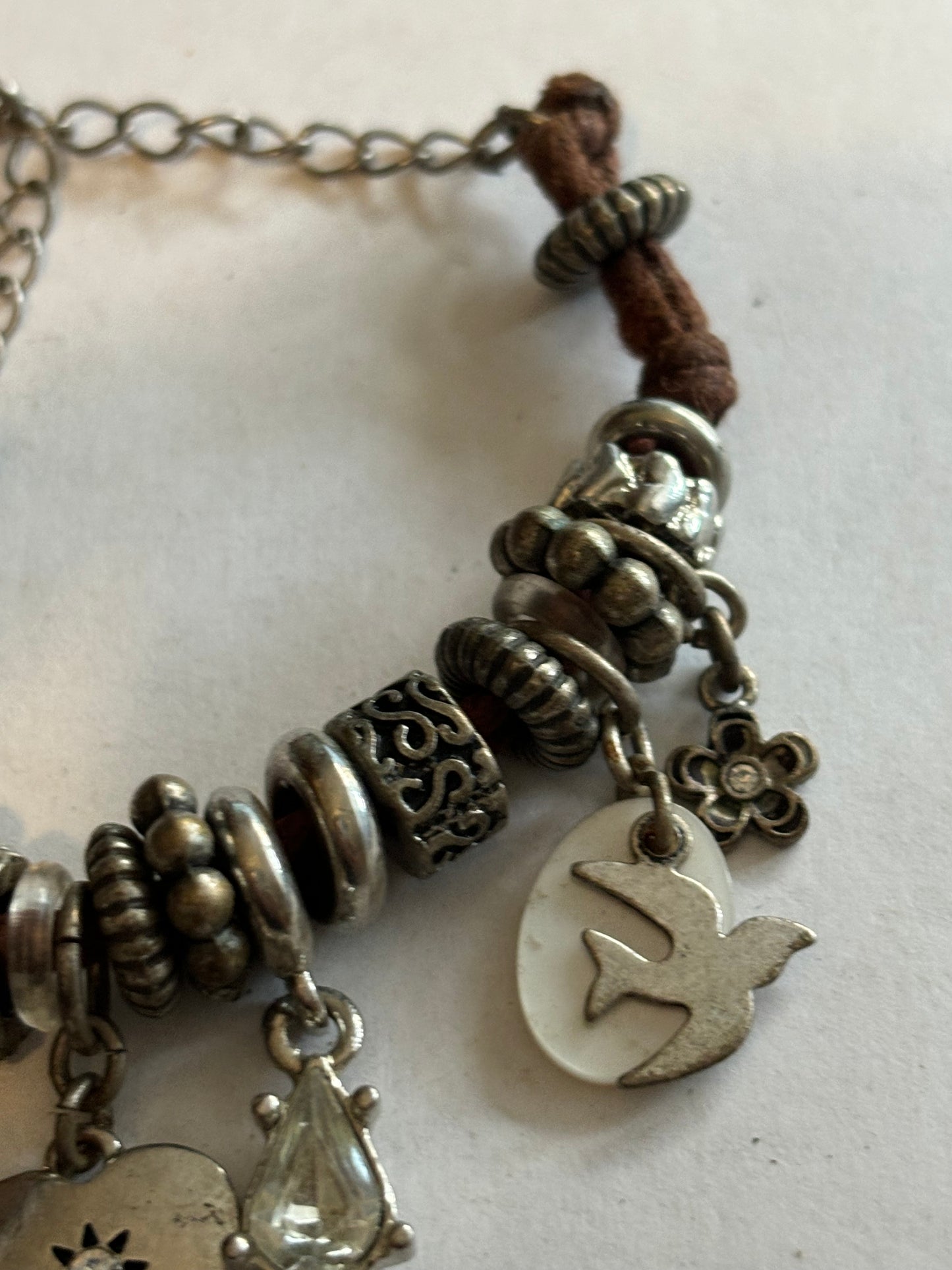 NEXT - Brown string and silver charm bracelet