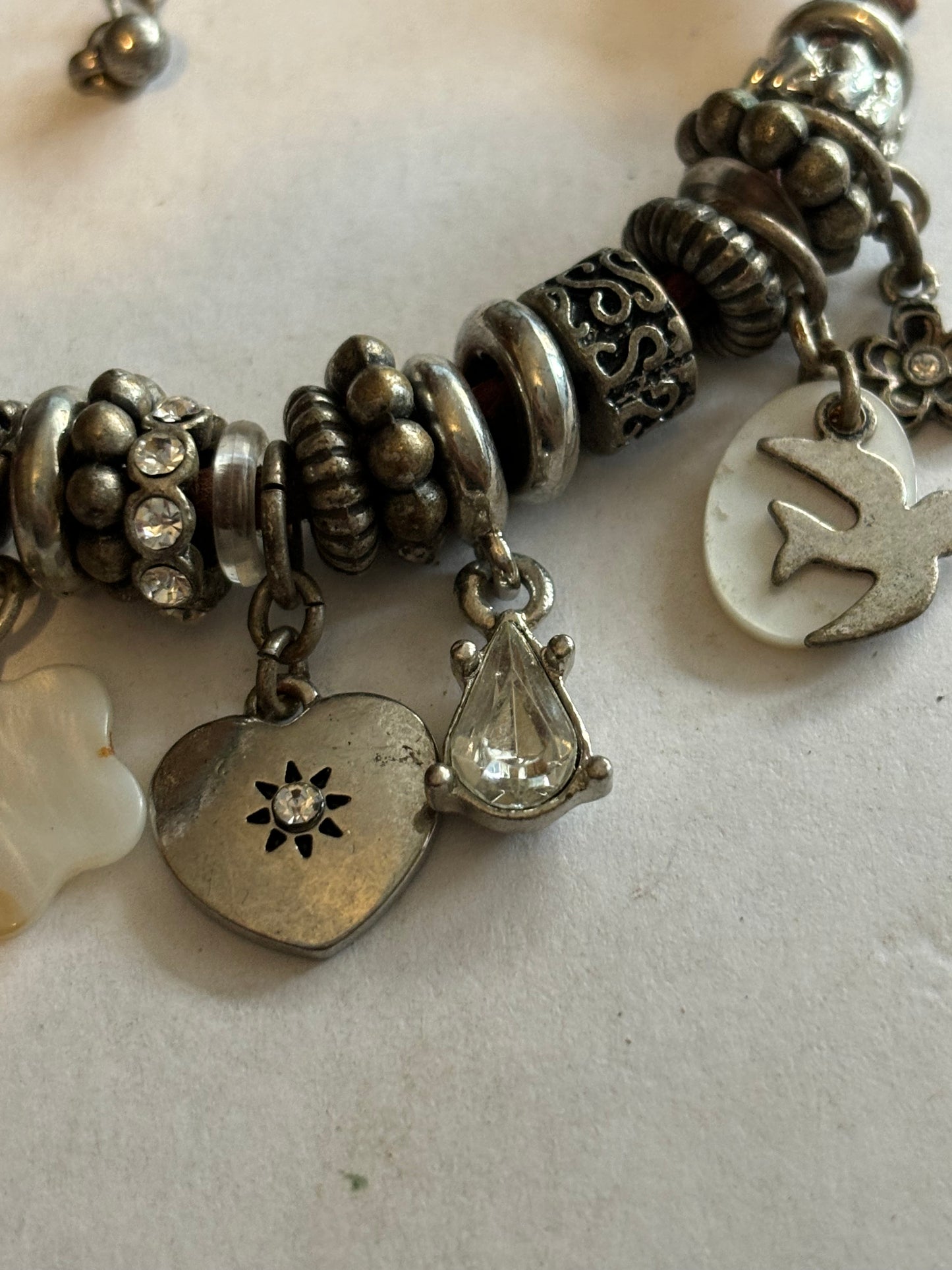 NEXT - Brown string and silver charm bracelet