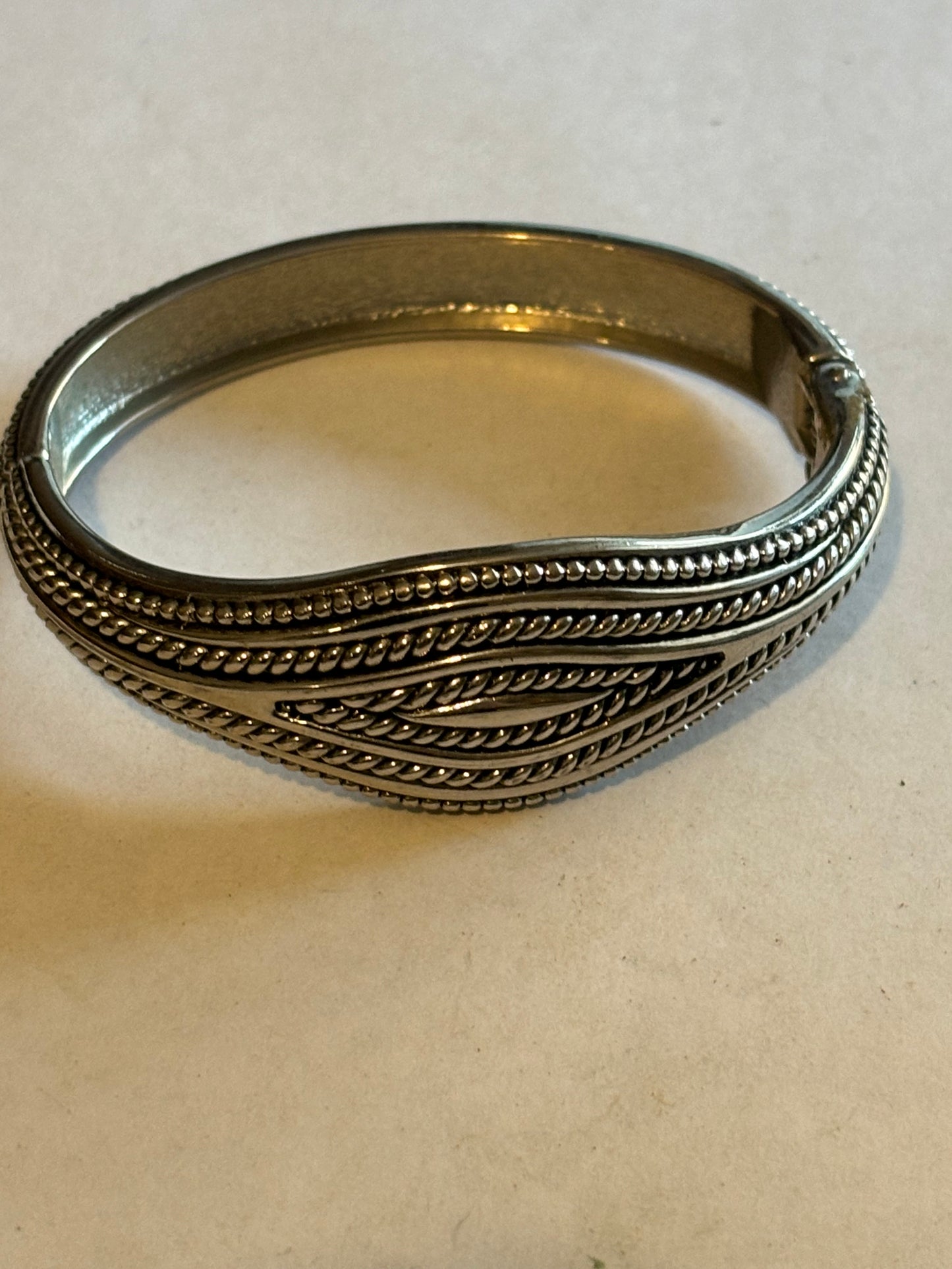 Silver metal spring bangle with bobble pattern, almost rope like