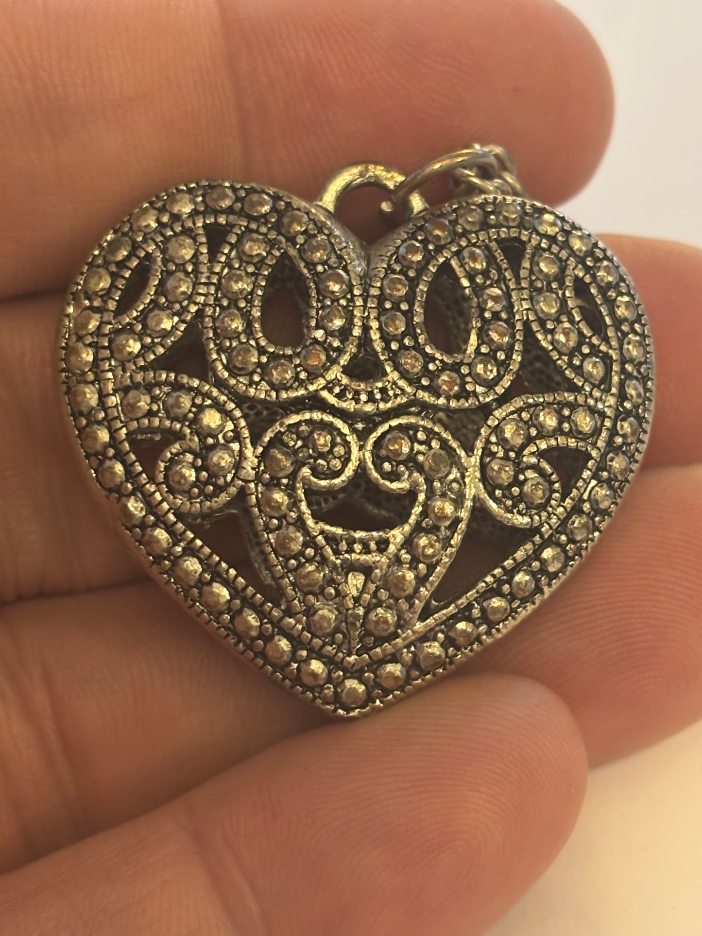 Long silver necklace with ornate 3D heart pendant