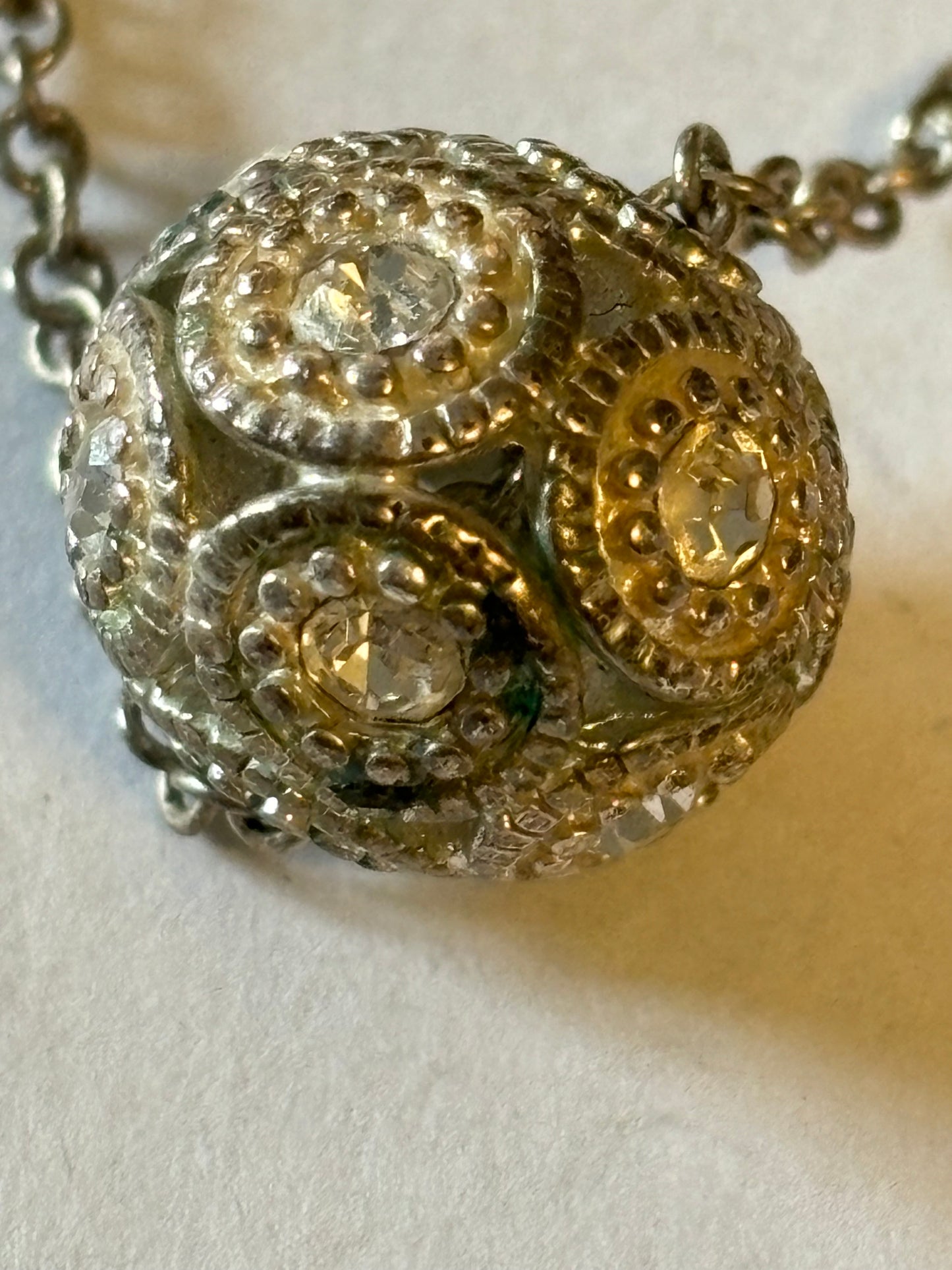 Silver metal necklace with white stone decorative sphere pendant