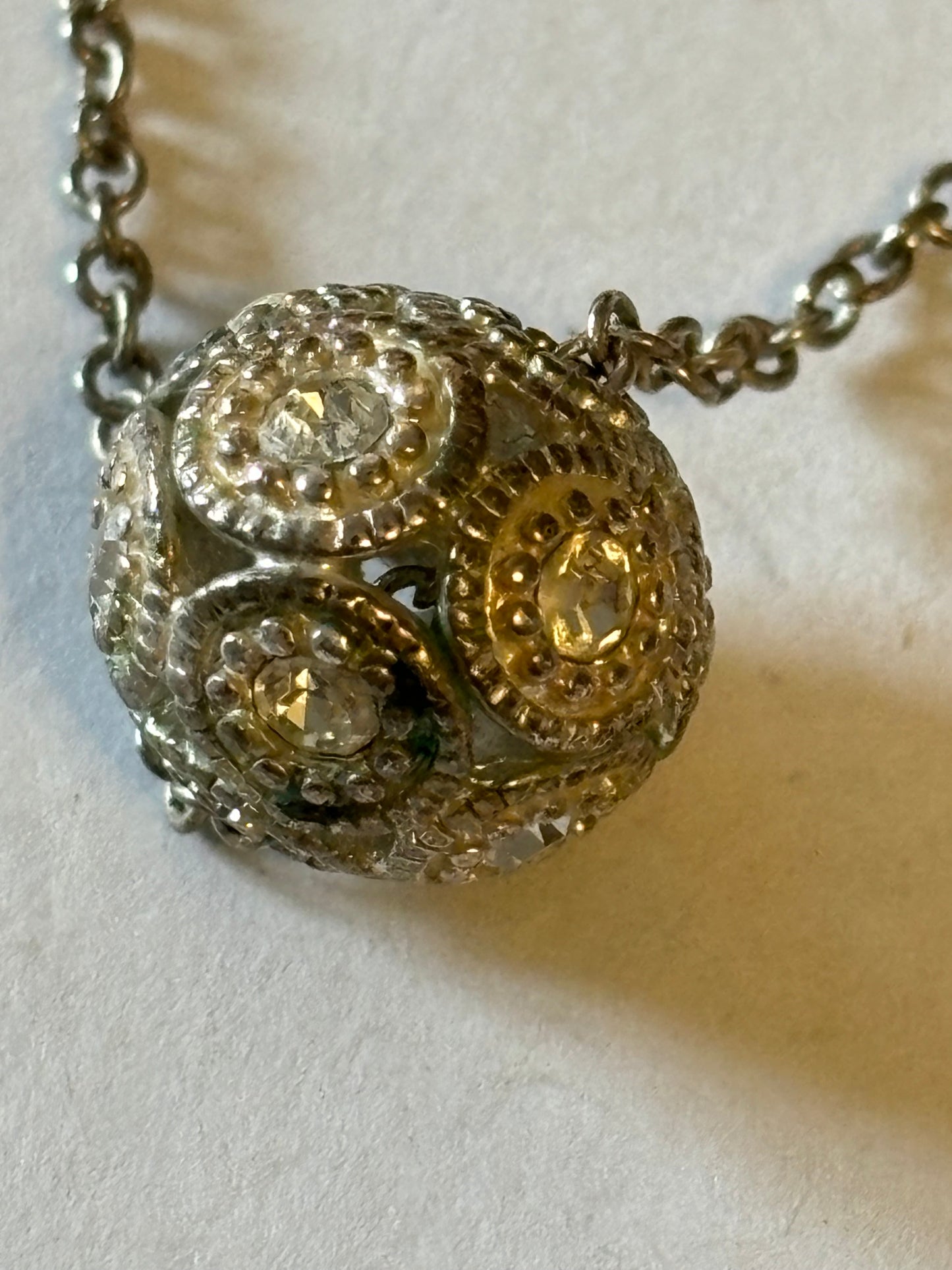 Silver metal necklace with white stone decorative sphere pendant