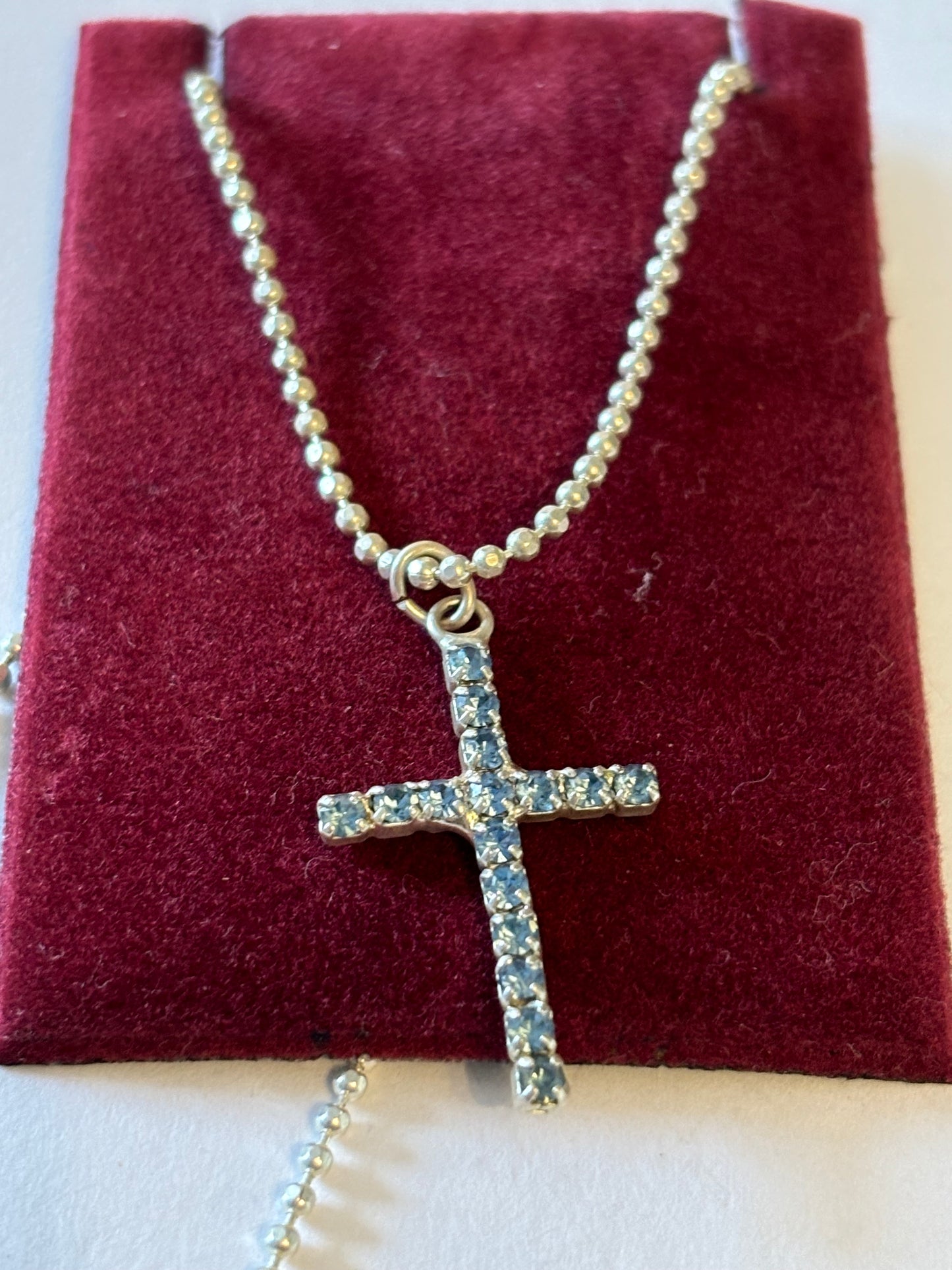 Silver bead chain necklace with blue diamante cross pendant