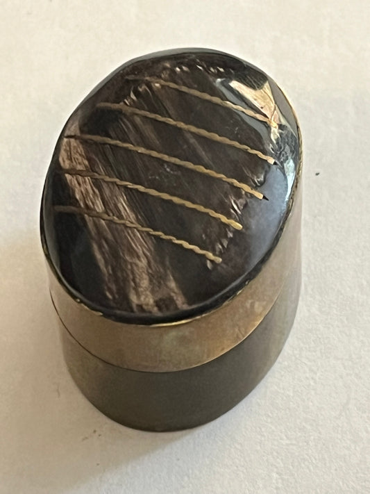 Small oval brass pill pot with black and white mineral top