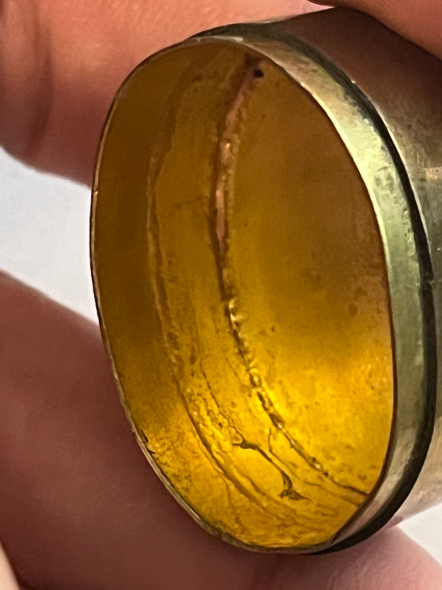 Small oval brass pill pot with black and white mineral top