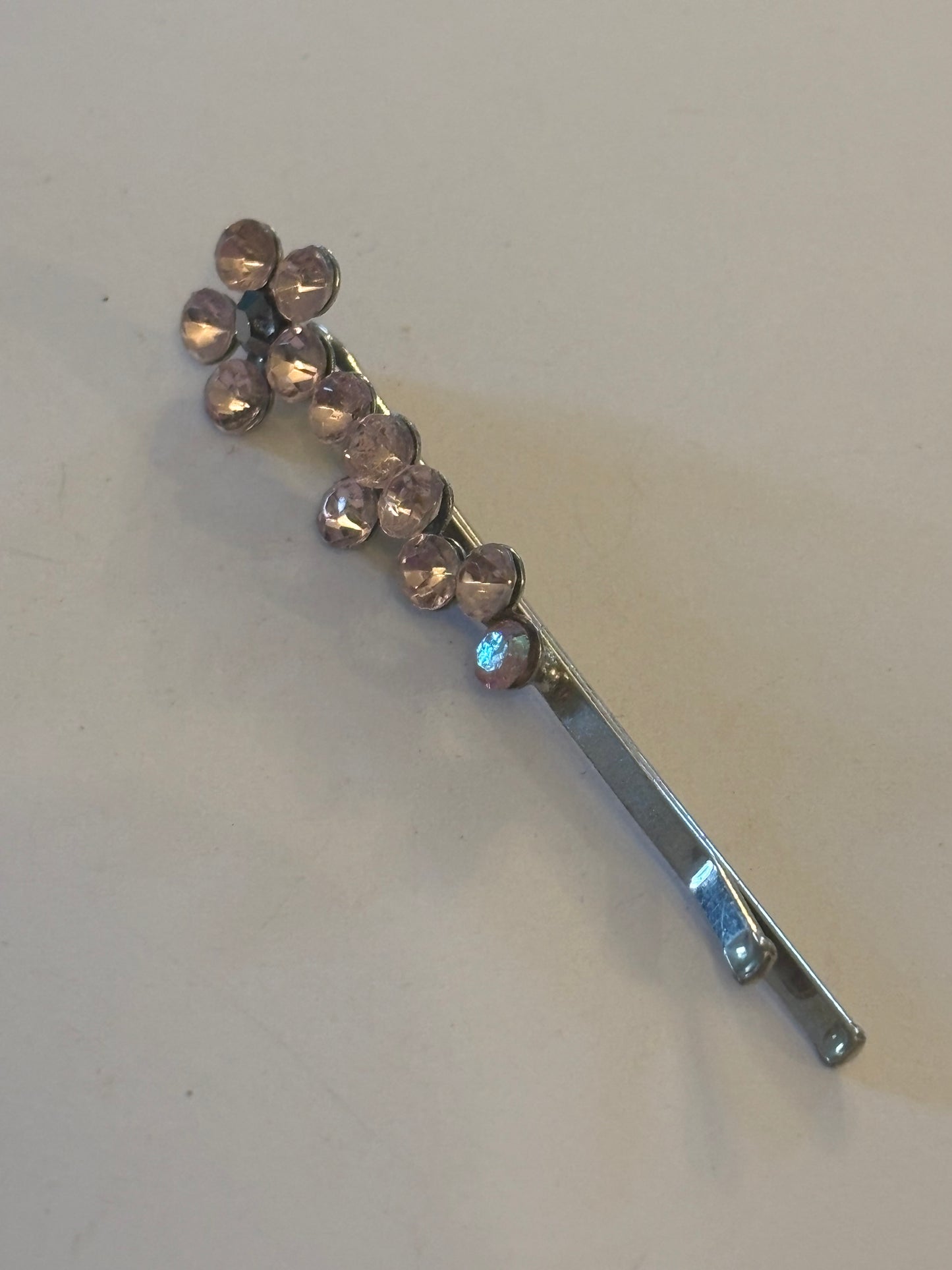 Small silver metal hair grip with clear purple light stones