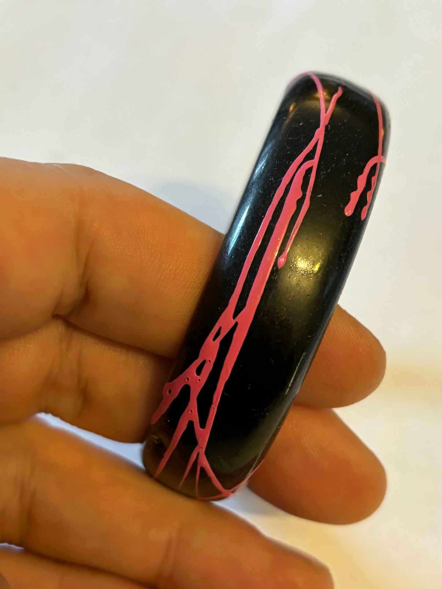 Black bangle with electric pink streaks