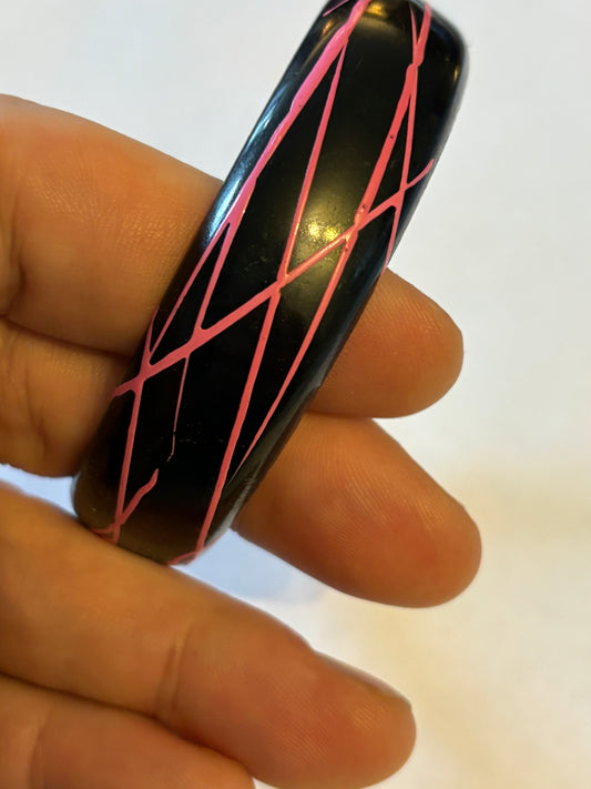 Black bangle with electric pink streaks