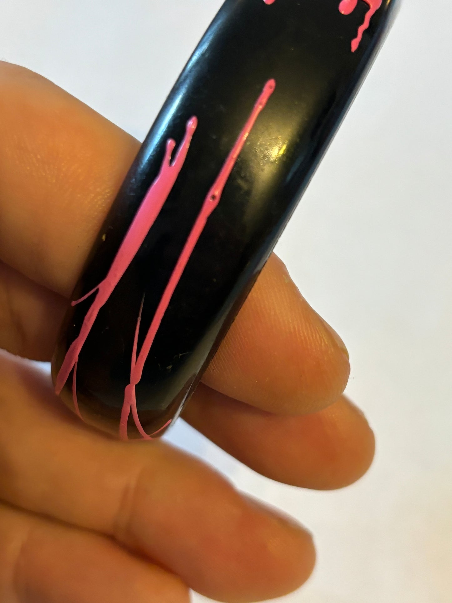 Black bangle with electric pink streaks