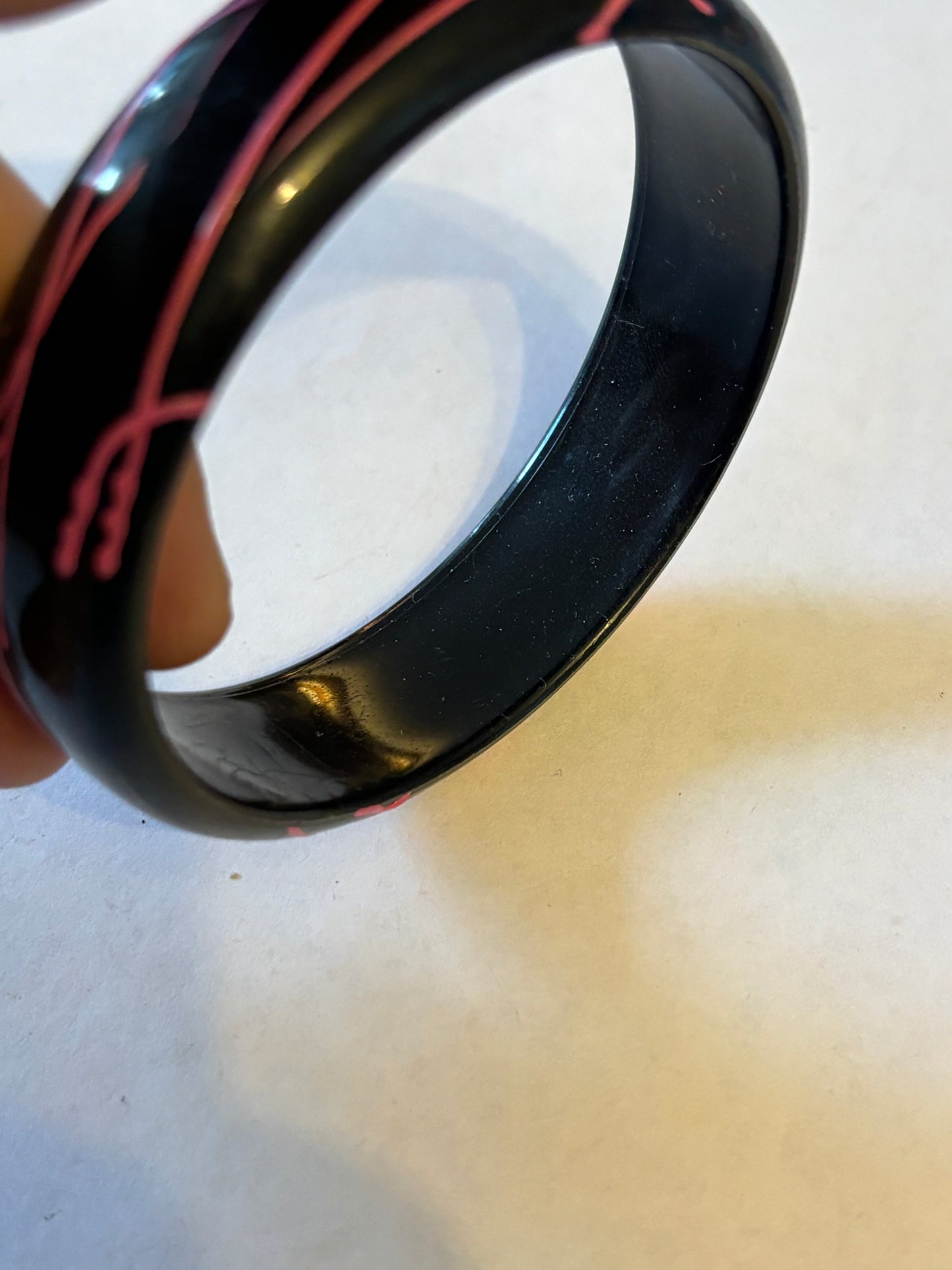 Black bangle with electric pink streaks