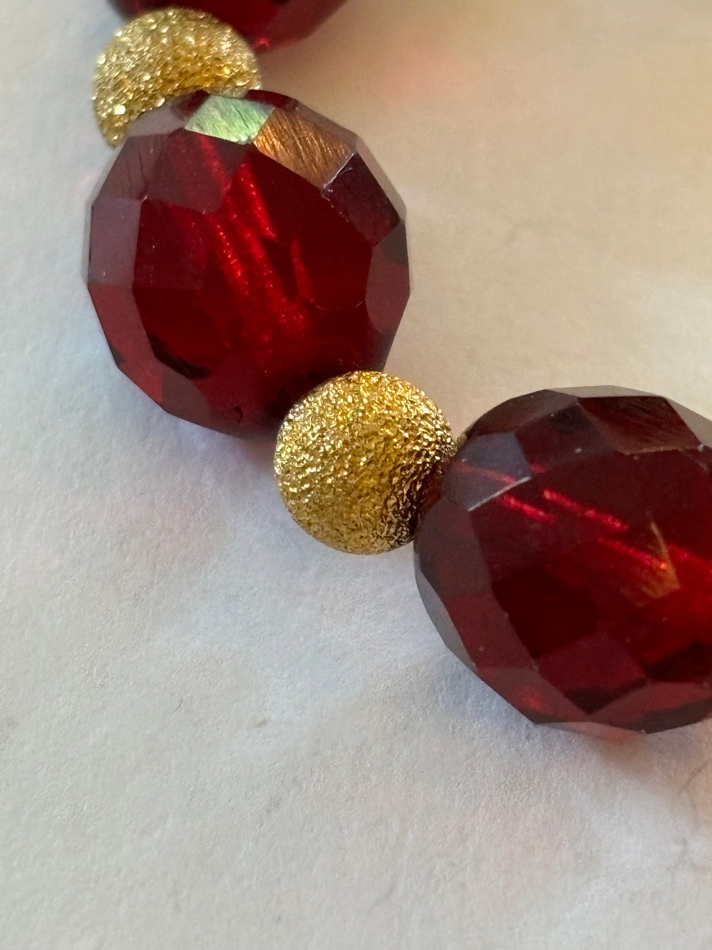 Bright red bead bracelet with gold sparkly spacers