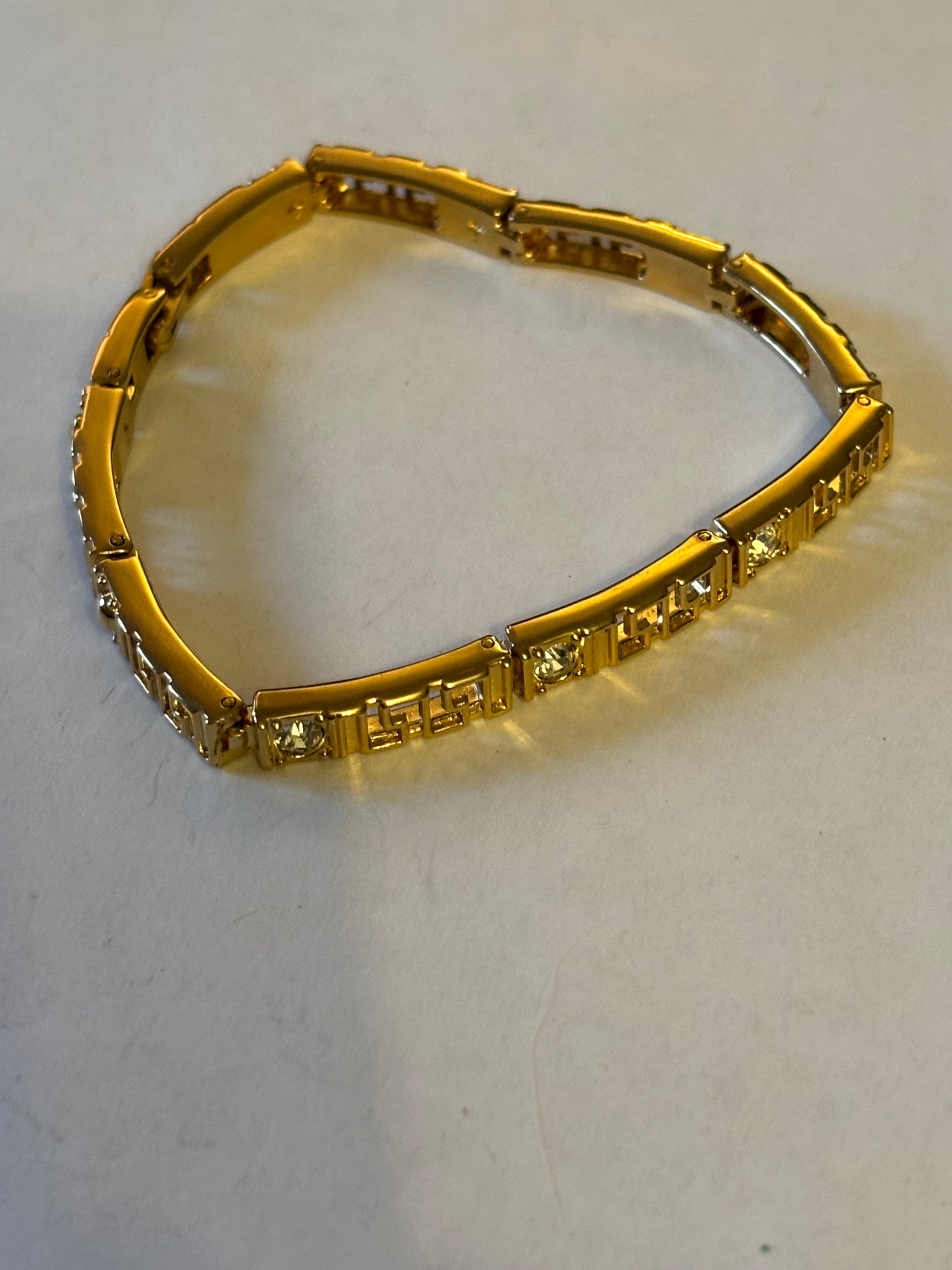 Gold long link decorative bracelet with inset white stones