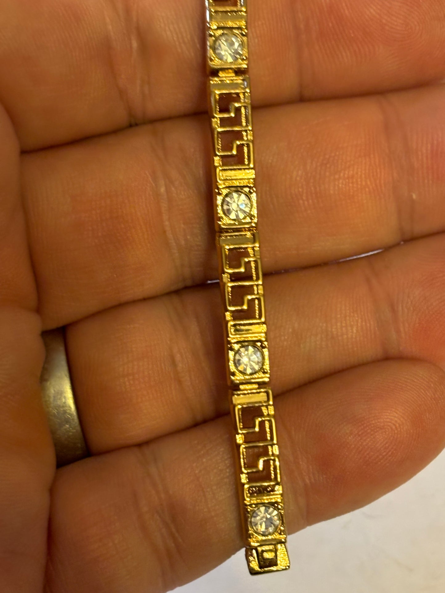 Gold long link decorative bracelet with inset white stones