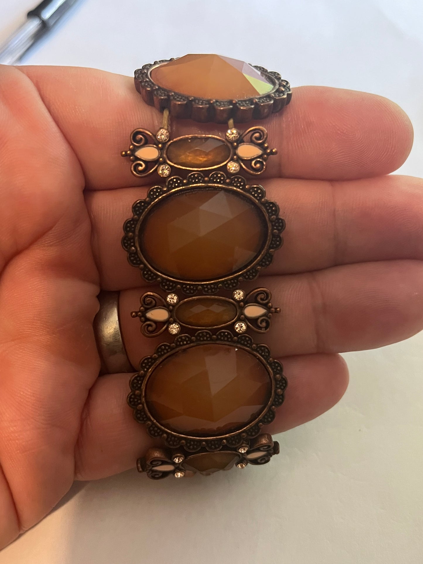 Large bronzey metal dark panel bracelet with oval caramel stones