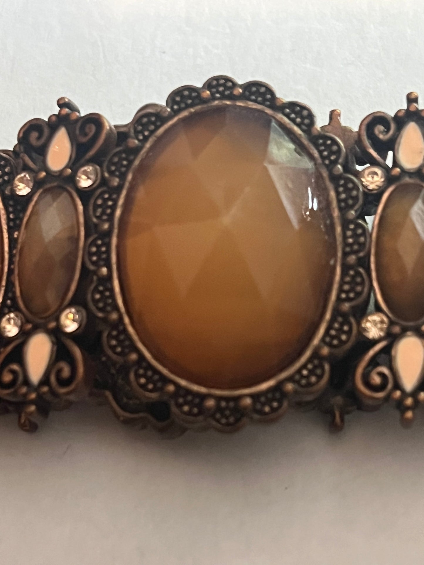 Large bronzey metal dark panel bracelet with oval caramel stones