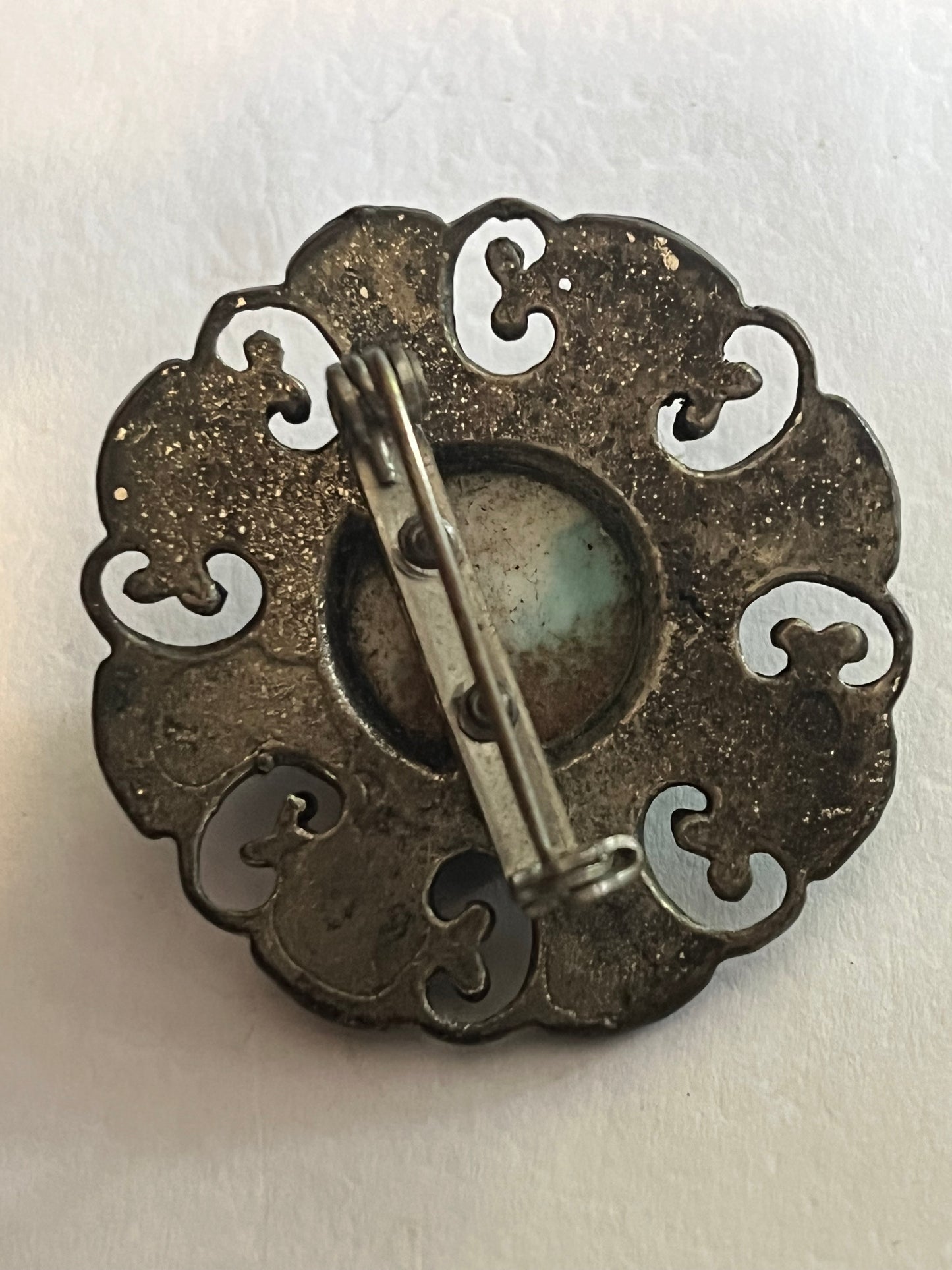 Round Ornate Silver metal brooch with marbled turquoise centre