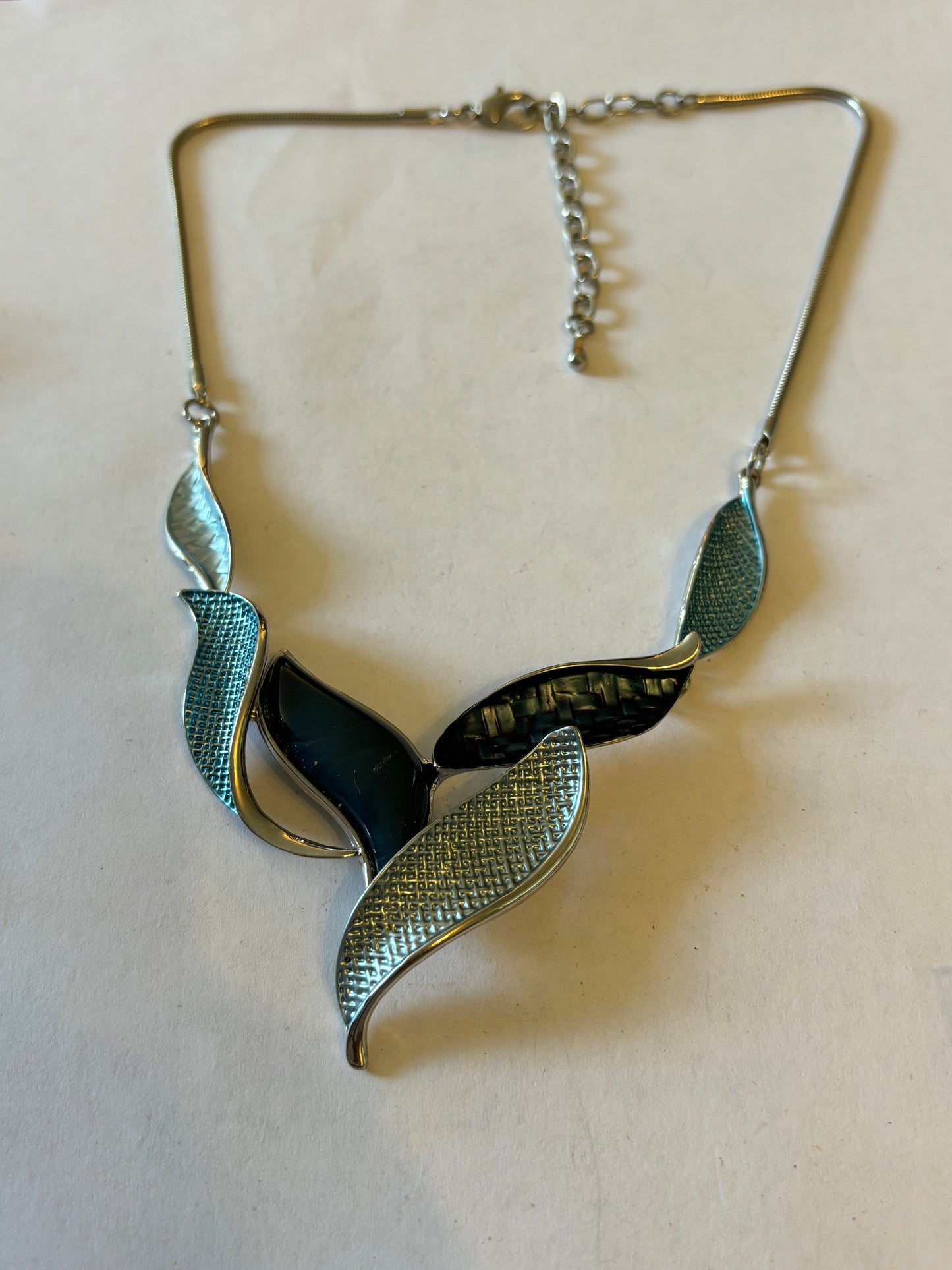 Silver smooth rope necklace with large silver entwined blue leaf pendant