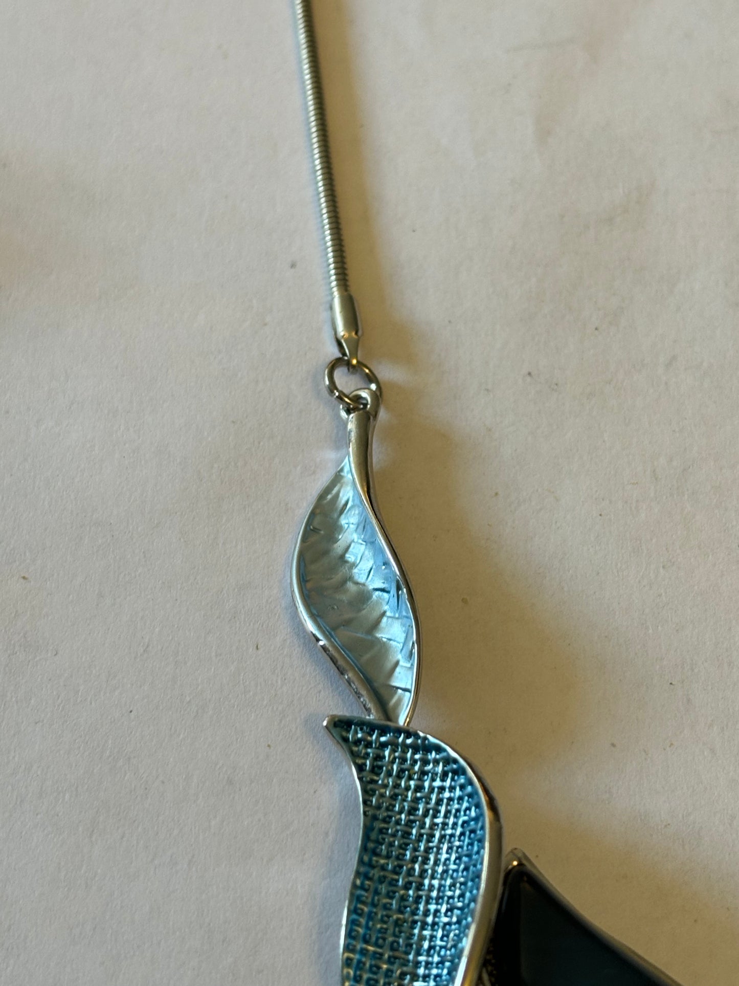 Silver smooth rope necklace with large silver entwined blue leaf pendant