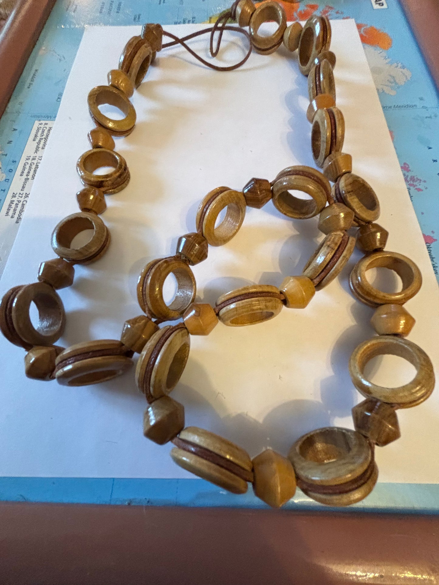 Very long glossy wooden rings and bead necklace