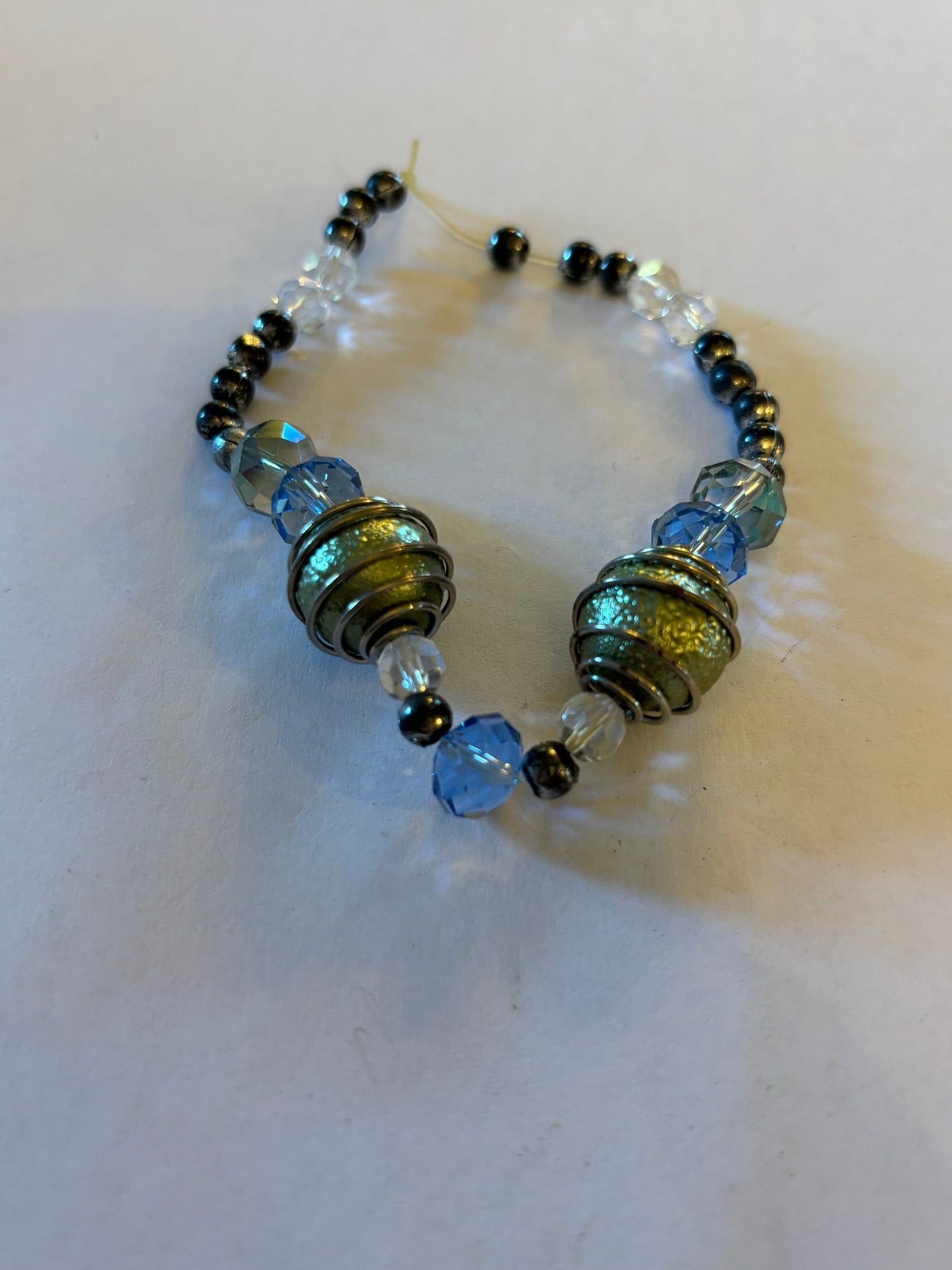 Silver, clear blue and gold beaded bracelet