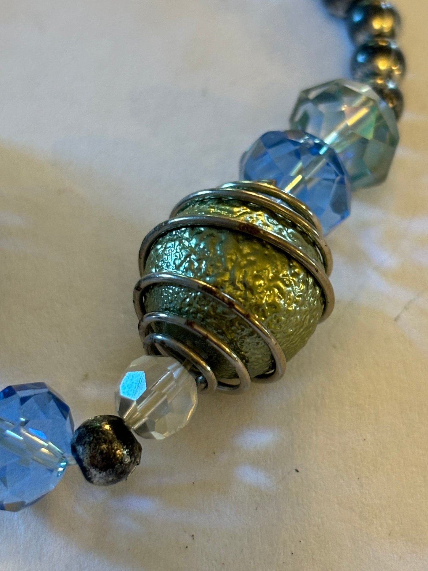 Silver, clear blue and gold beaded bracelet