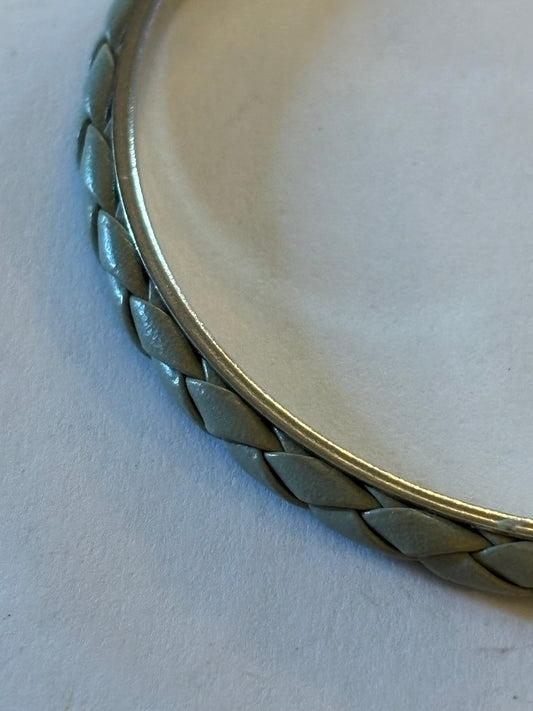 Thin silver metal solid bangle with grey leather weave