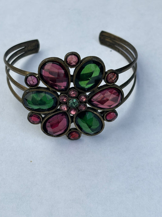 Brass triple wire bangle with central flower of green and purple stones