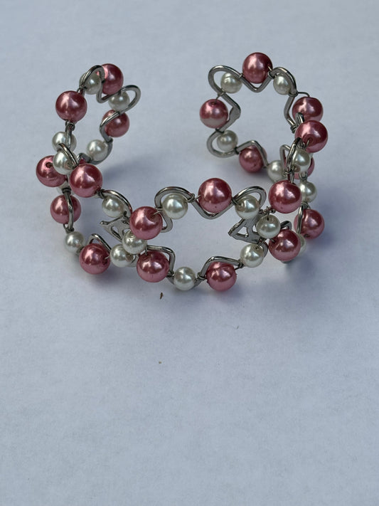 Silver metal star shape bangle with pink and white pearlescent beads