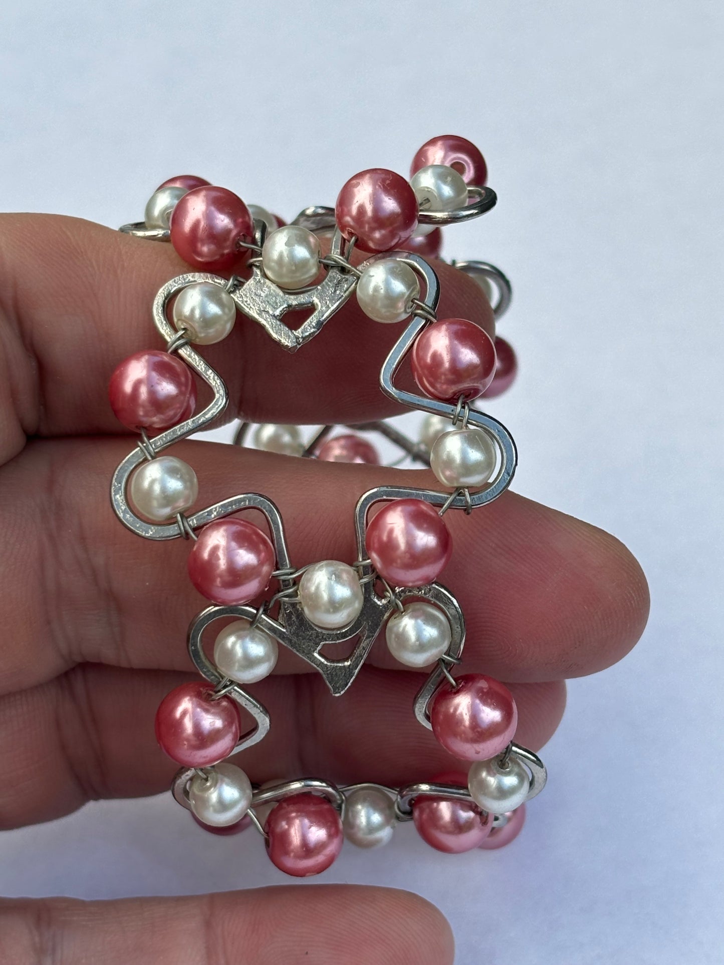 Silver metal star shape bangle with pink and white pearlescent beads