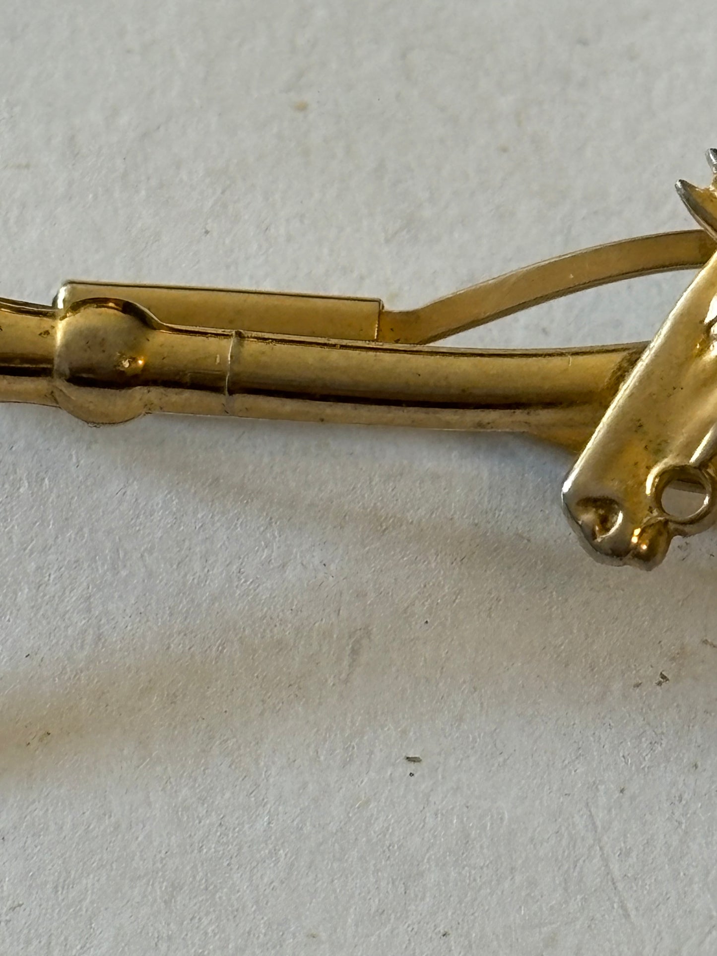 Gold metal horse and riding crop tie clip