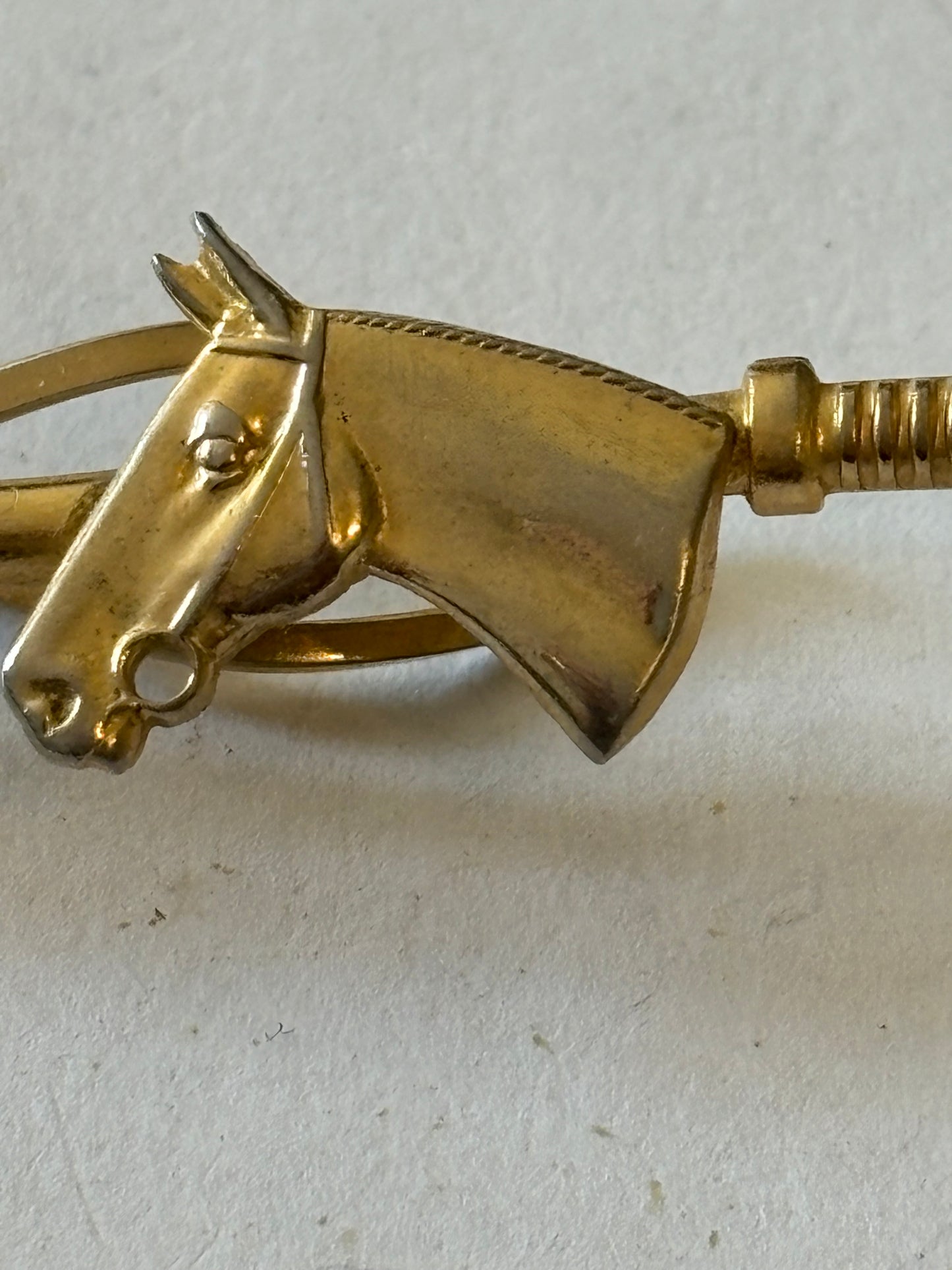 Gold metal horse and riding crop tie clip