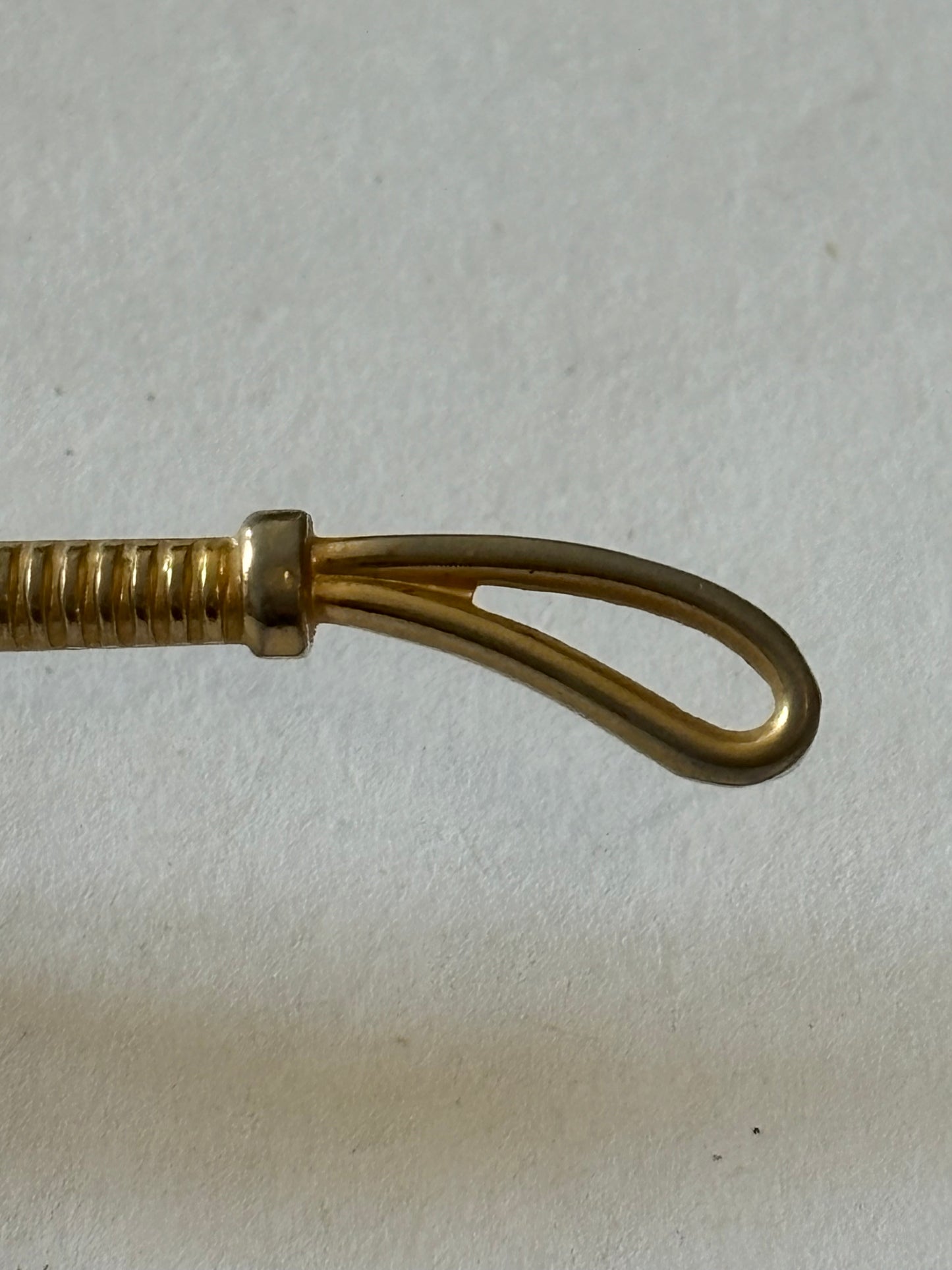 Gold metal horse and riding crop tie clip