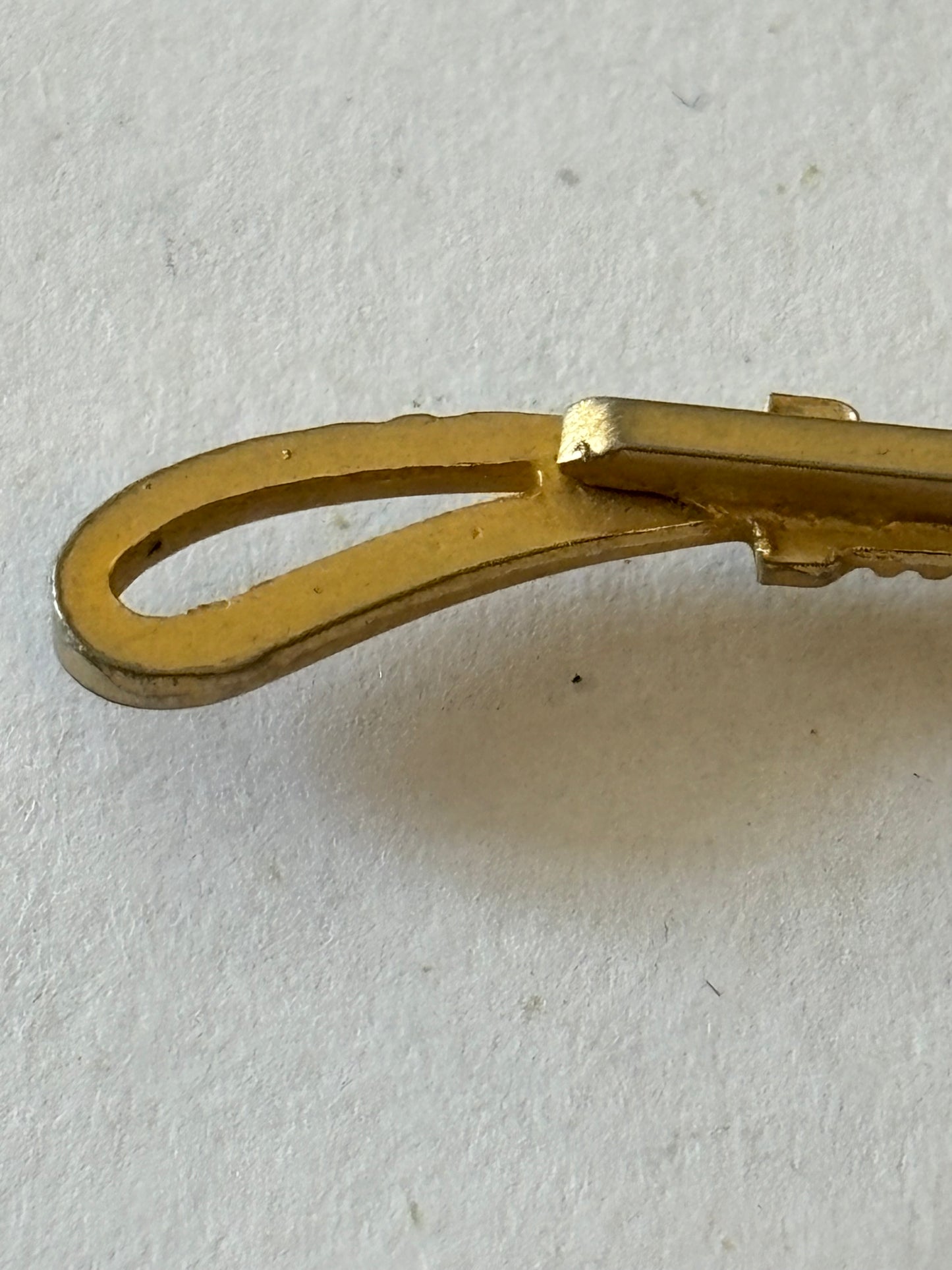 Gold metal horse and riding crop tie clip