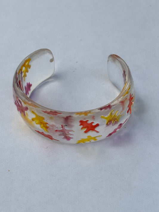 Small thick clear open bangle with leaf shapes