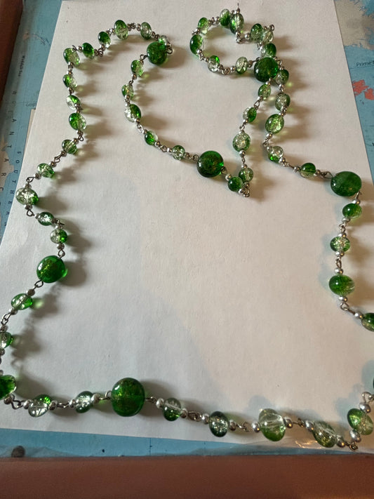 Long silver necklace with green spaced beads