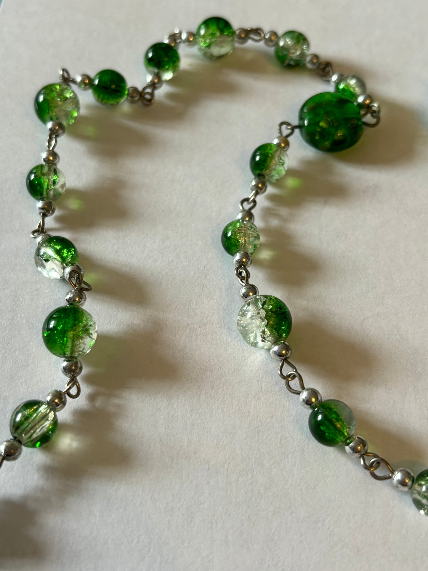 Long silver necklace with green spaced beads