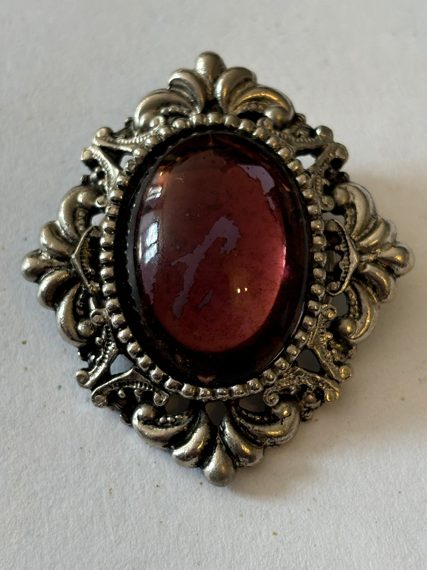 Ornate vintage scarf clip with oval purple stone