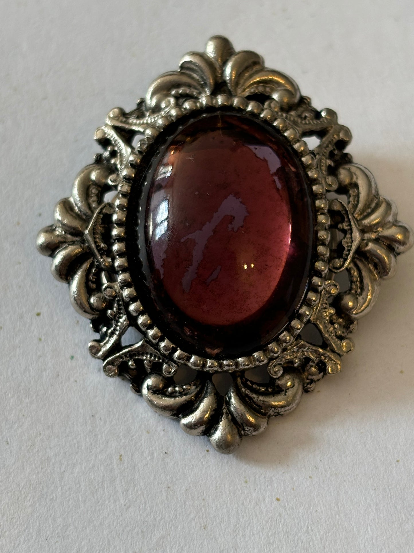 Ornate vintage scarf clip with oval purple stone