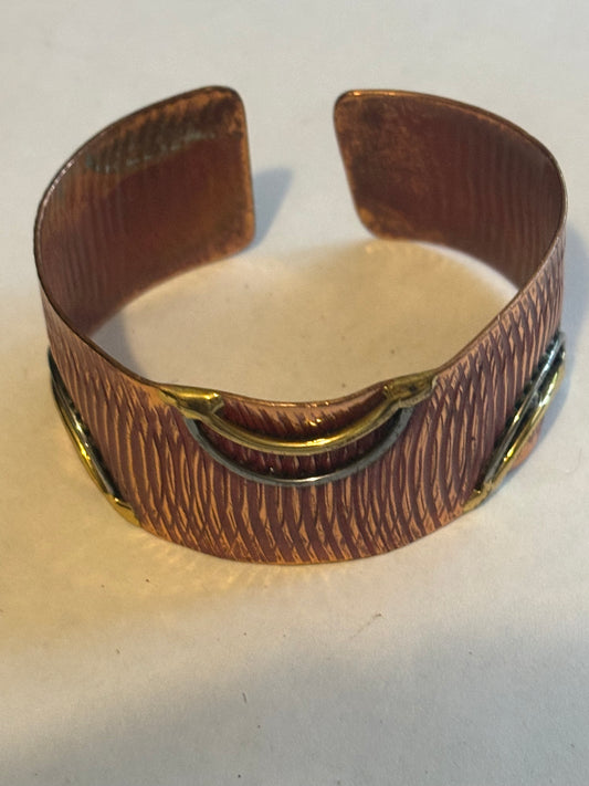 Copper coloured ridged bangle with gold decoration