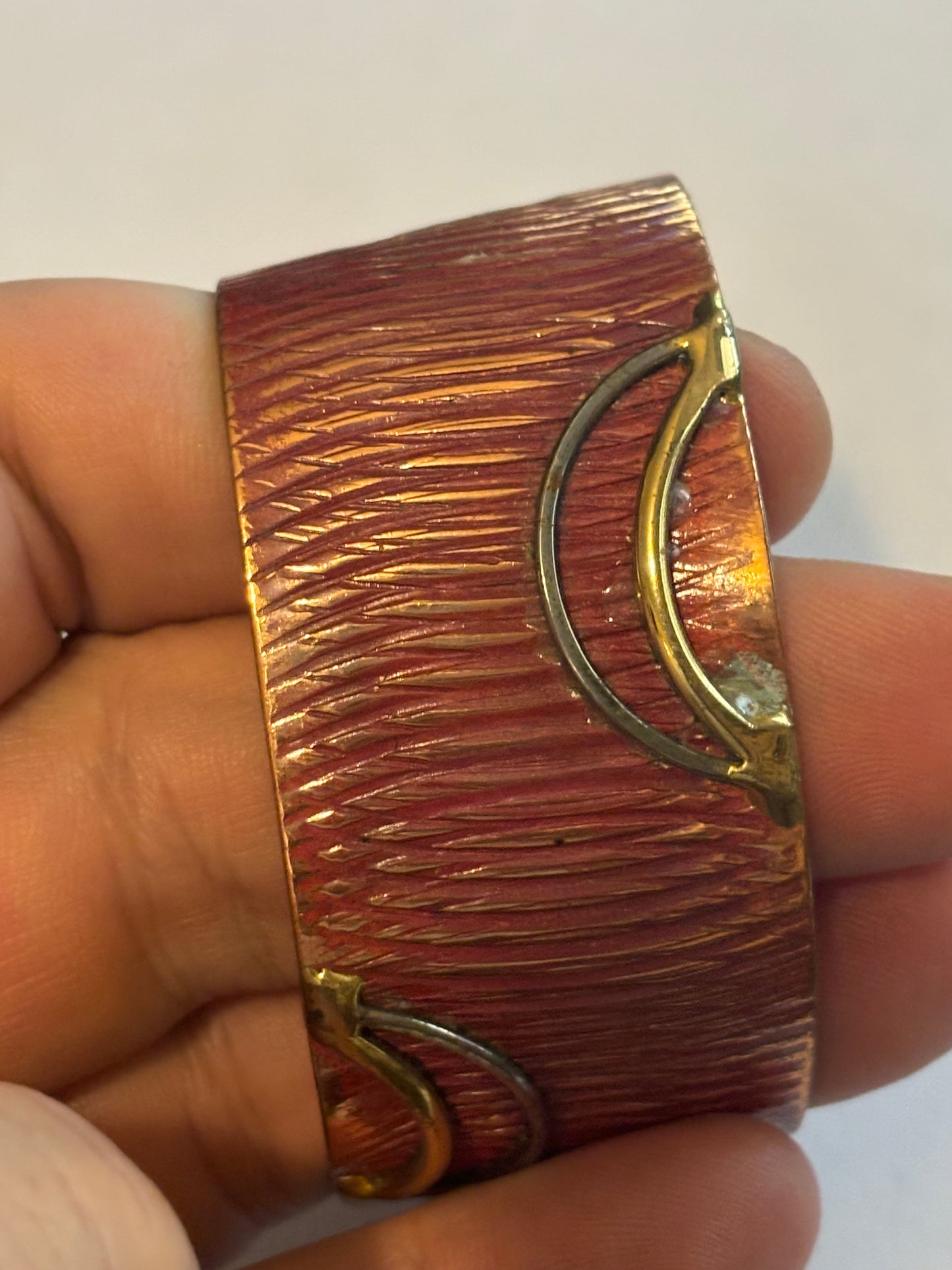 Copper coloured ridged bangle with gold decoration