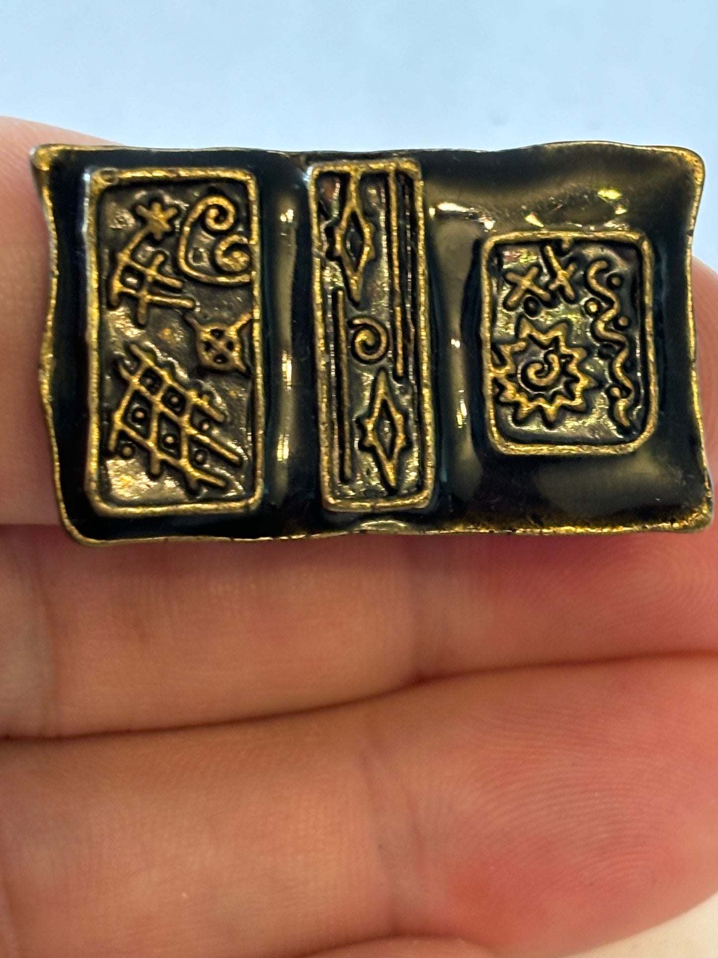 Dark metal ring with large rectangular flat patterned top